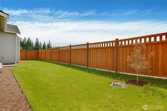 view of yard with a fenced backyard