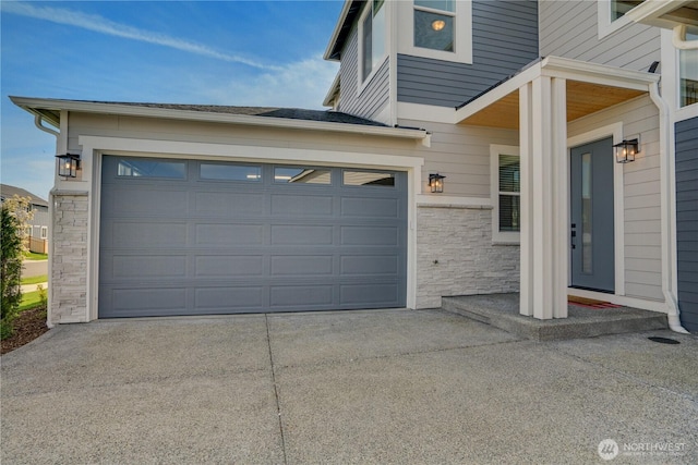 garage featuring concrete driveway