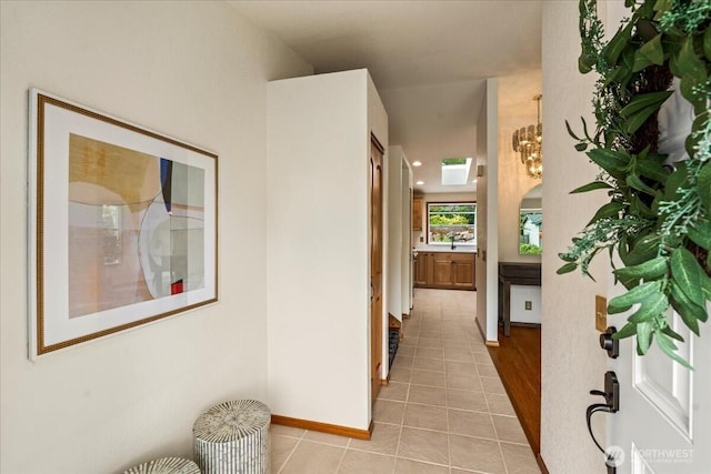 1129 235th Pl SW, Bothell, WA 98021 - corridor featuring light tile patterned floors, baseboards, and a sink