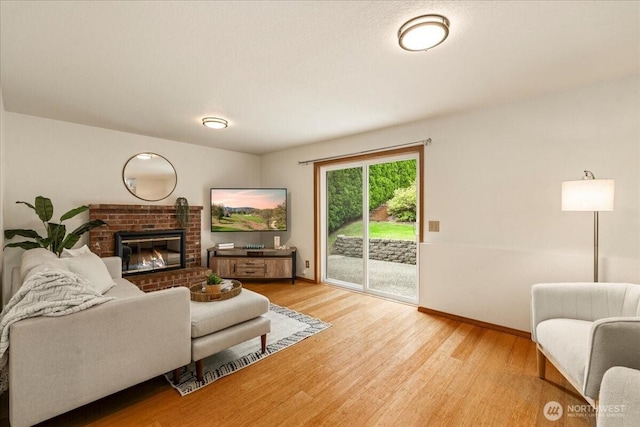 1129 235th Pl SW, Bothell, WA 98021 - living area with light wood-style floors, baseboards, and a fireplace