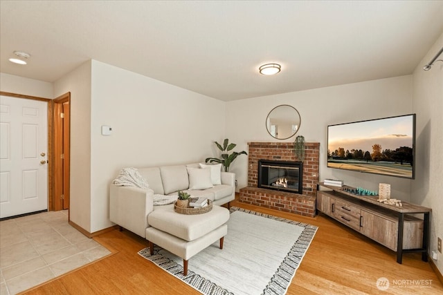 1129 235th Pl SW, Bothell, WA 98021 - living area with light wood-style flooring, a brick fireplace, and baseboards