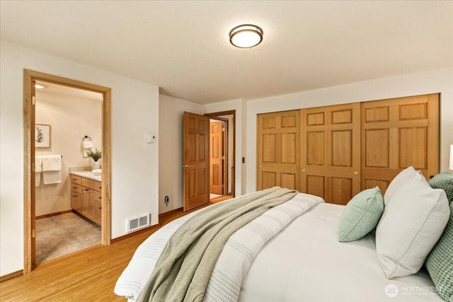 1129 235th Pl SW, Bothell, WA 98021 - bedroom with a closet, light wood-style flooring, ensuite bath, and baseboards