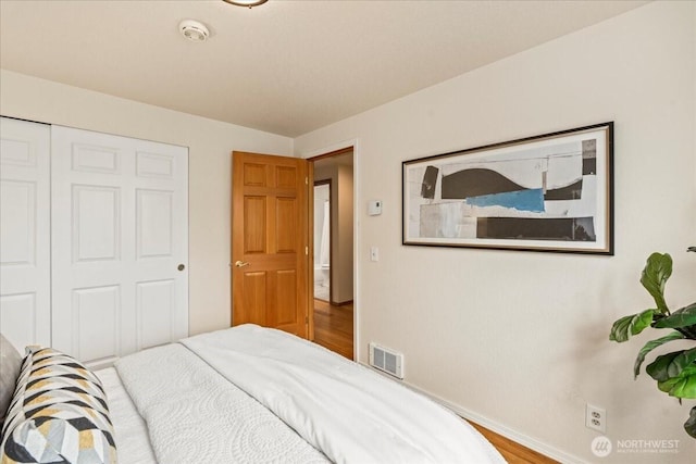1129 235th Pl SW, Bothell, WA 98021 - bedroom with baseboards, wood finished floors, and a closet
