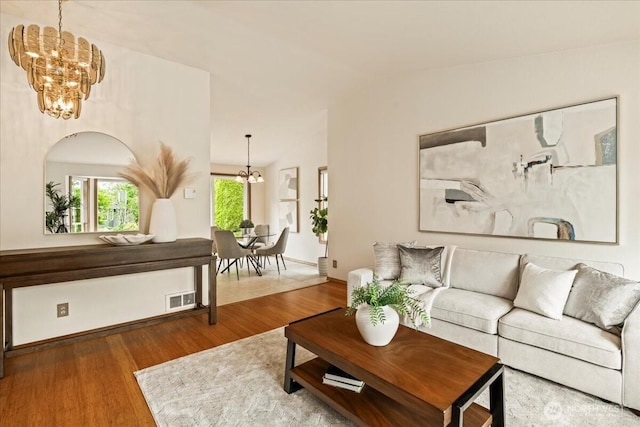 1129 235th Pl SW, Bothell, WA 98021 - living room featuring a chandelier, wood finished floors, and vaulted ceiling
