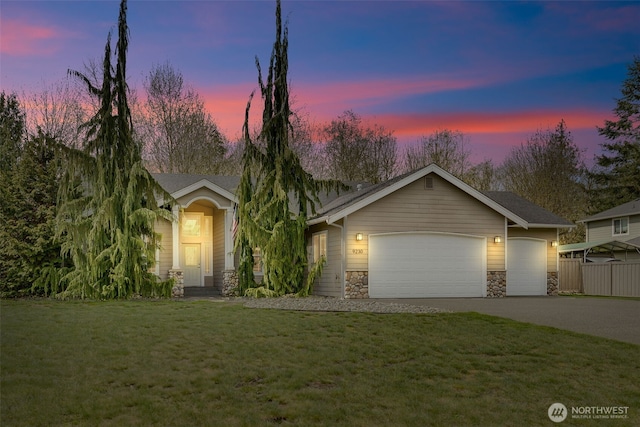 view of front of home featuring a yard, an attached garage, stone siding, fence, and concrete driveway