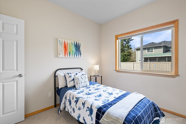 bedroom featuring baseboards and carpet