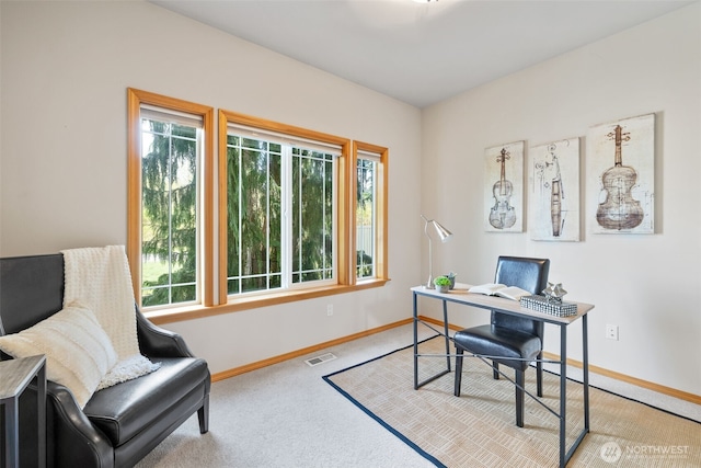 carpeted home office featuring visible vents and baseboards