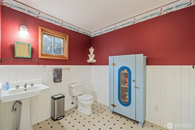 3404 Oysterville Rd, Oysterville, WA 98641 - half bath with toilet, tile patterned floors, and wainscoting