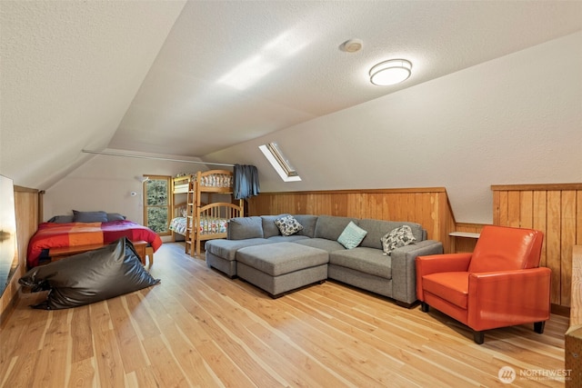 3404 Oysterville Rd, Oysterville, WA 98641 - interior space with lofted ceiling with skylight, light wood-style floors, and a textured ceiling