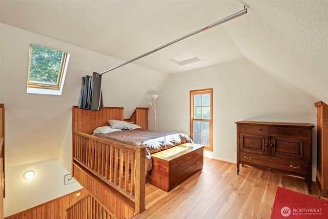 3404 Oysterville Rd, Oysterville, WA 98641 - bedroom featuring lofted ceiling, a textured ceiling, and light wood-type flooring