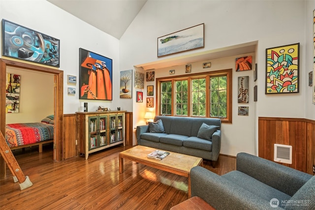 3404 Oysterville Rd, Oysterville, WA 98641 - living area featuring a wainscoted wall, high vaulted ceiling, wood finished floors, and wood walls