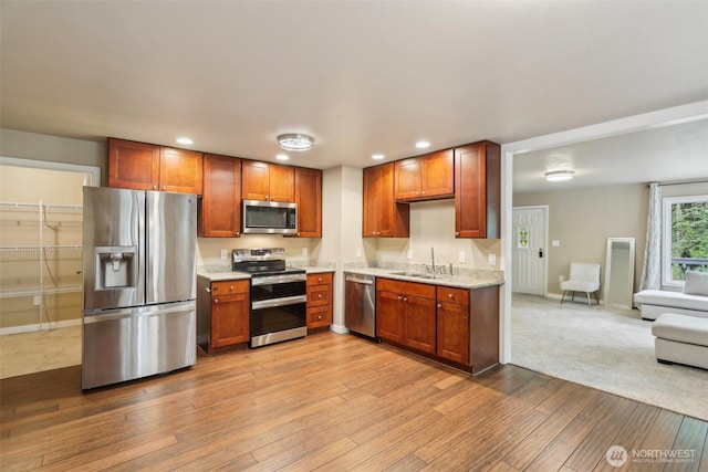 24010 SE 168th St, Issaquah, WA 98027 - kitchen with appliances with stainless steel finishes, a sink, recessed lighting, hardwood / wood-style floors, and baseboards