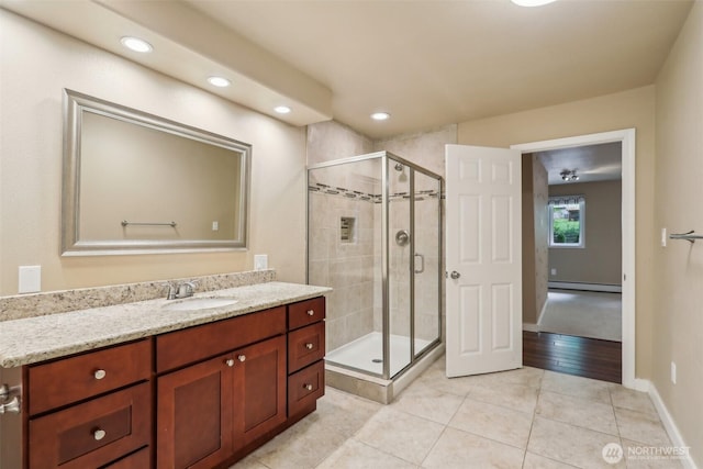24010 SE 168th St, Issaquah, WA 98027 - bathroom with baseboard heating, tile patterned flooring, vanity, a stall shower, and recessed lighting