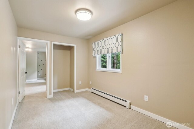 24010 SE 168th St, Issaquah, WA 98027 - unfurnished bedroom with a baseboard heating unit, light colored carpet, and baseboards