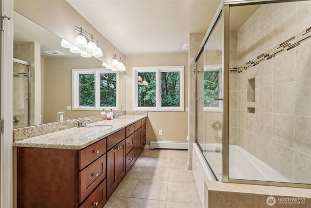 24010 SE 168th St, Issaquah, WA 98027 - full bath with a baseboard radiator, tile patterned floors, double vanity, tiled shower / bath, and baseboards