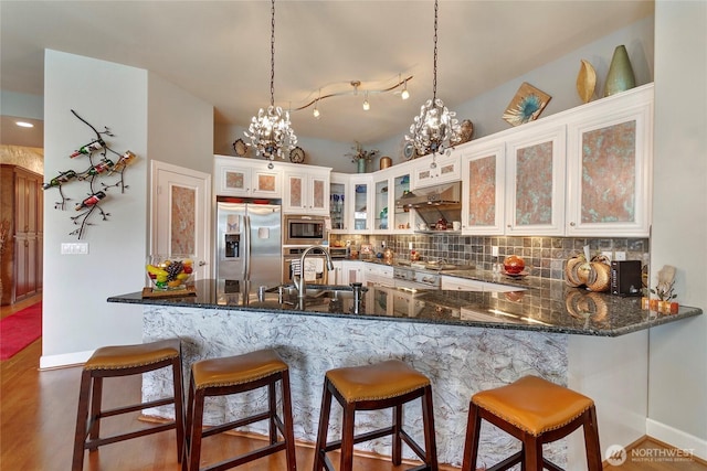 400S Meridian Unit 2A, Puyallup, WA 98371 - kitchen featuring tasteful backsplash, stainless steel appliances, a sink, a peninsula, and a notable chandelier