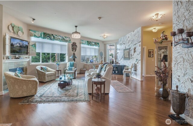 400S Meridian Unit 2A, Puyallup, WA 98371 - living room featuring baseboards, a fireplace, and wood finished floors