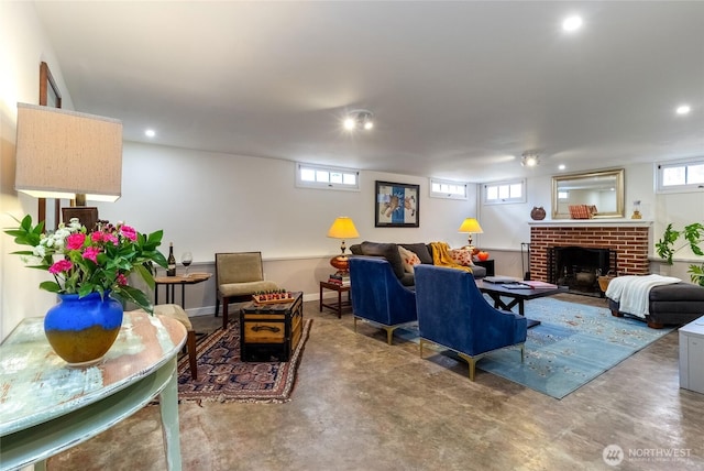 living room with a fireplace, concrete floors, and recessed lighting