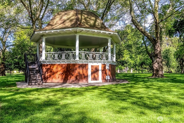 back of house featuring stairs, a gazebo, and a yard