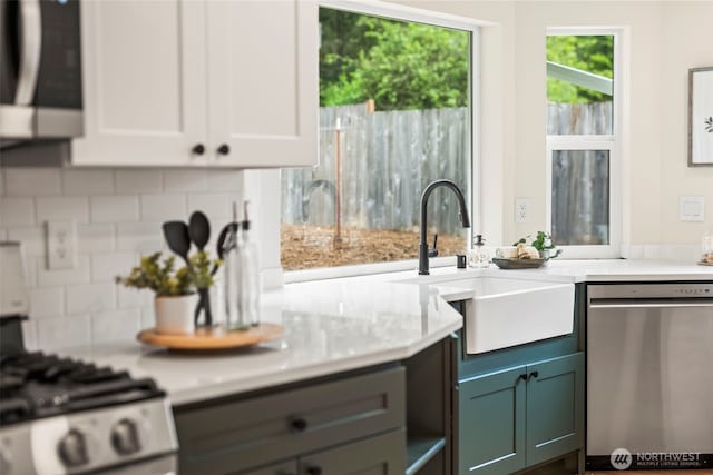 19713 17th St SW, Lakebay, WA 98349 - kitchen with appliances with stainless steel finishes, a sink, tasteful backsplash, and white cabinets