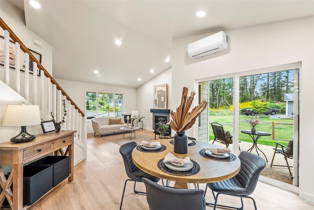 19713 17th St SW, Lakebay, WA 98349 - dining room featuring a wall mounted air conditioner, stairs, recessed lighting, light wood finished floors, and a fireplace