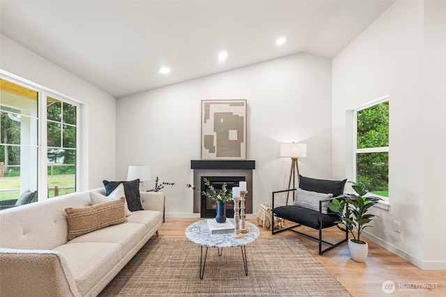 19713 17th St SW, Lakebay, WA 98349 - living room with healthy amount of natural light, wood finished floors, vaulted ceiling, recessed lighting, and baseboards