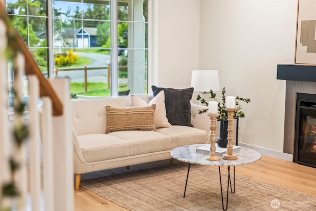 19713 17th St SW, Lakebay, WA 98349 - living room with wood finished floors, a glass covered fireplace, and baseboards