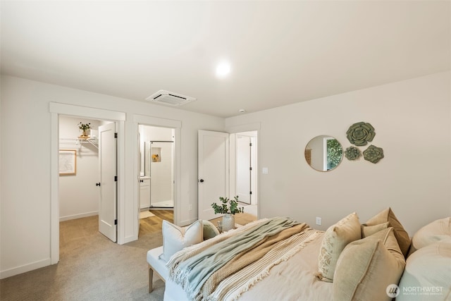 19713 17th St SW, Lakebay, WA 98349 - bedroom featuring a walk in closet, baseboards, light carpet, a closet, and ensuite bath