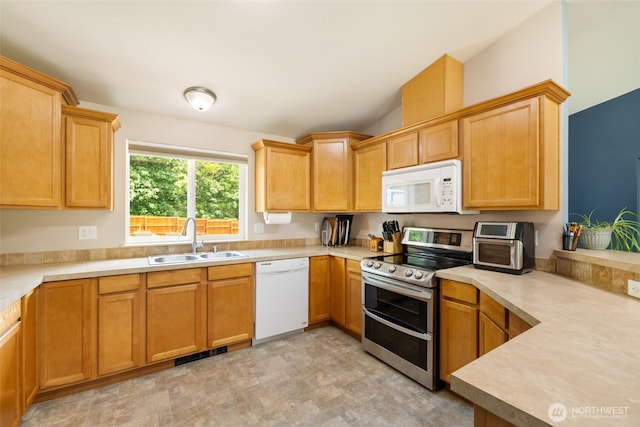 231 E Heights Pl N, Belfair, WA 98528 - kitchen featuring white appliances, light countertops, stone finish floors, and vaulted ceiling