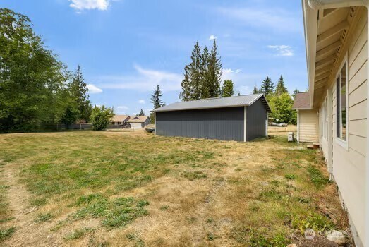 231 E Heights Pl N, Belfair, WA 98528 - view of green lawn with an outbuilding