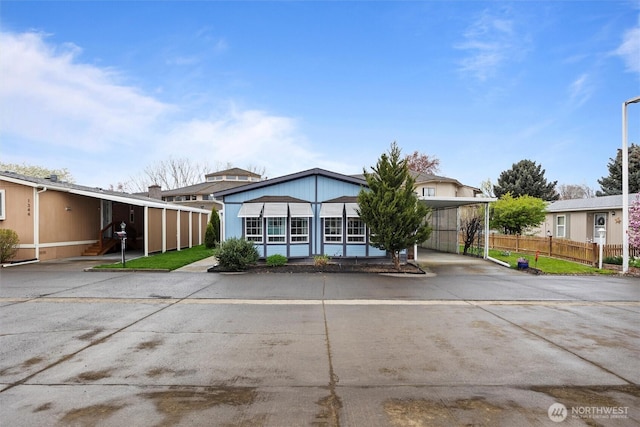 1340 Gloria Ln, Walla Walla, WA 99362 - view of front facade with a carport, fence, and concrete driveway
