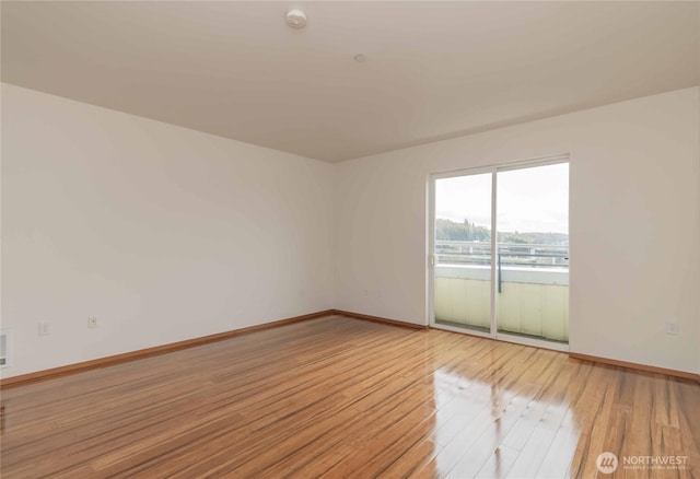 668S Lane St Unit 702, Seattle, WA 98104 - unfurnished room with baseboards and light wood-type flooring