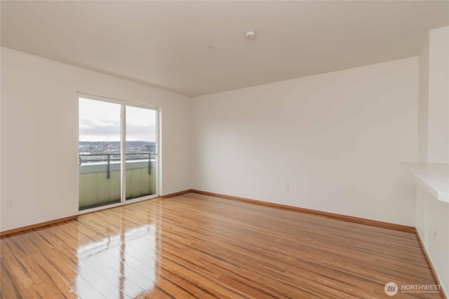 668S Lane St Unit 702, Seattle, WA 98104 - unfurnished room featuring baseboards and wood finished floors