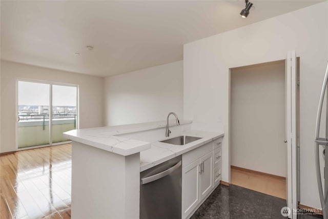668S Lane St Unit 702, Seattle, WA 98104 - kitchen with a sink, light wood-style floors, dishwasher, white cabinets, and light stone countertops