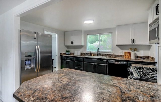 9807 S Lake Stevens Rd, Lake Stevens, WA 98258 - kitchen with appliances with stainless steel finishes, a sink, white cabinets, and dark stone countertops