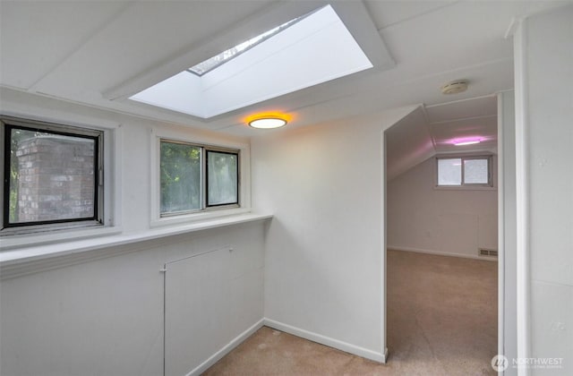 9807 S Lake Stevens Rd, Lake Stevens, WA 98258 - empty room with light carpet, a skylight, baseboards, a smoke detector, and lofted ceiling