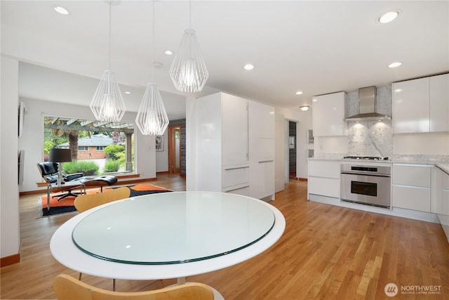 3754 SW 107th St, Seattle, WA 98146 - kitchen featuring oven, wall chimney exhaust hood, modern cabinets, light wood-type flooring, and recessed lighting