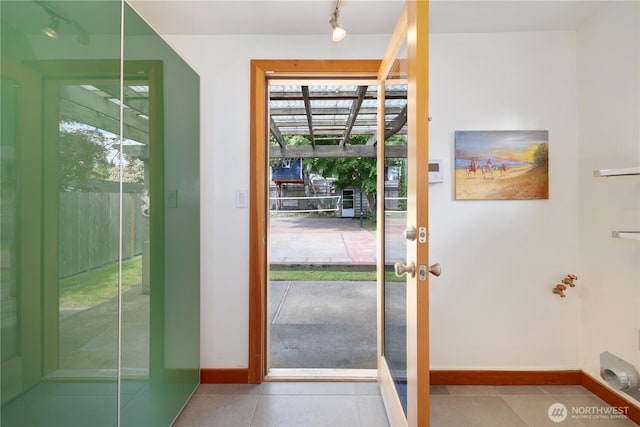 3754 SW 107th St, Seattle, WA 98146 - doorway with baseboards, healthy amount of natural light, tile patterned floors, and track lighting