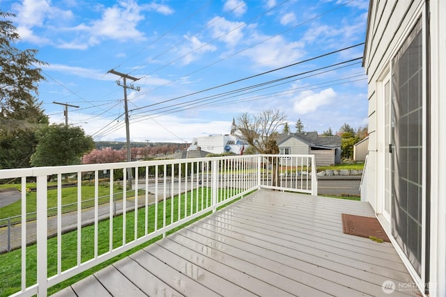 wooden terrace with a lawn
