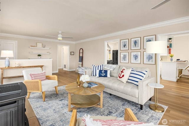 living area with light wood-style floors, ceiling fan, and crown molding