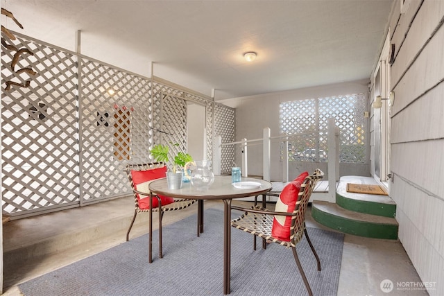 dining space featuring concrete flooring