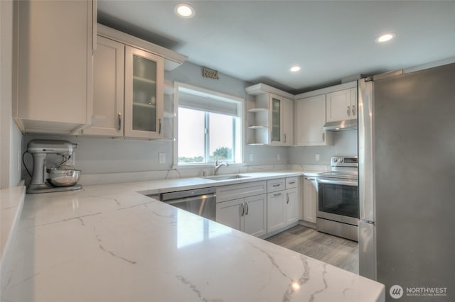 33 4th Ave, Ocean Shores, WA 98569 - kitchen featuring stainless steel appliances, recessed lighting, under cabinet range hood, a sink, and light stone counters