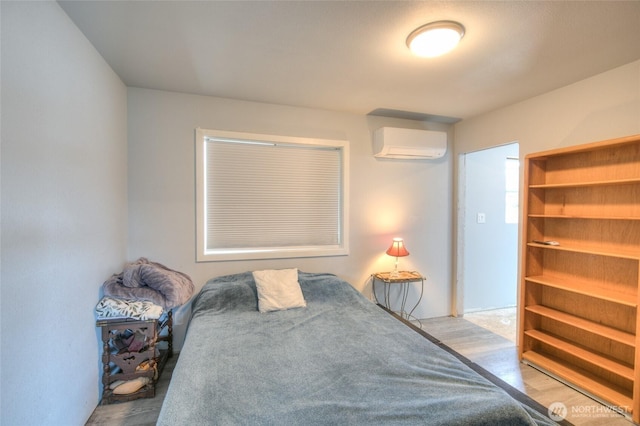 33 4th Ave, Ocean Shores, WA 98569 - bedroom featuring an AC wall unit and wood finished floors