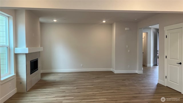 6414 213th Avenue Ct E, Bonney Lake, WA 98391 - unfurnished living room featuring wood finished floors, recessed lighting, and a fireplace