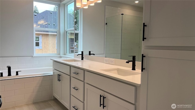 6414 213th Avenue Ct E, Bonney Lake, WA 98391 - bathroom with double vanity, a bath, and a tile shower