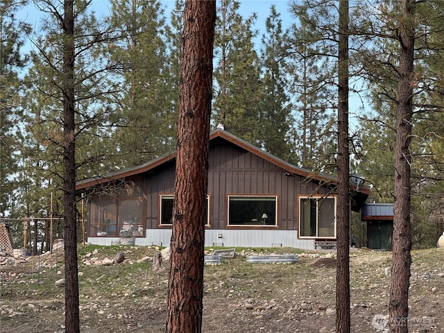 view of side of property featuring a sunroom