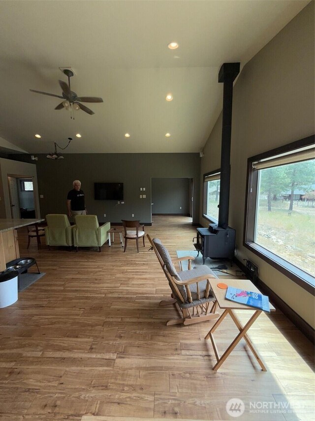 21 Twin Lakes Dr, Winthrop, WA 98862 - living room featuring a wood stove, light wood-style floors, recessed lighting, a ceiling fan, and high vaulted ceiling