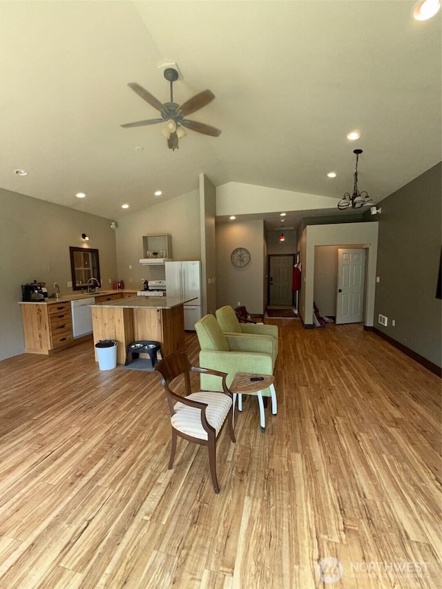 21 Twin Lakes Dr, Winthrop, WA 98862 - living room with light wood-style floors, vaulted ceiling, a ceiling fan, recessed lighting, and a chandelier