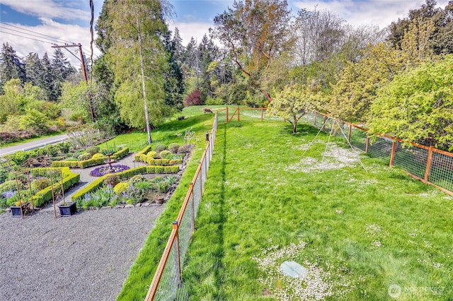 view of yard with a garden and fence