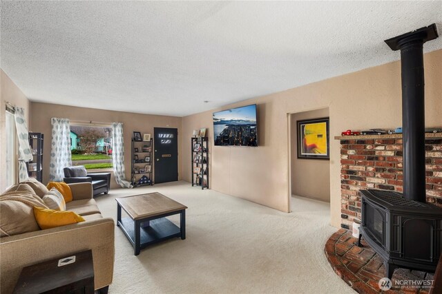 2824 Pacific Ave, Hoquiam, WA 98550 - living area with light carpet, a textured ceiling, and a wood stove